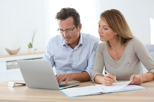 Jonge man en vrouw doen online aangifte inkomsten belastingen